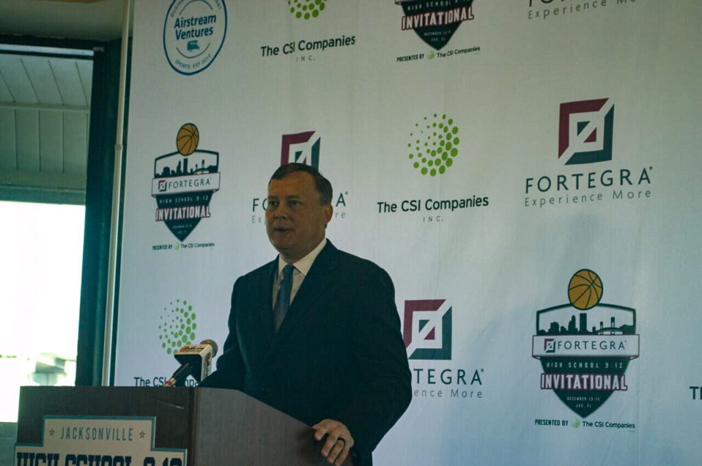 A speaker at a podium in front of Fortegra and The CSI Companies banners