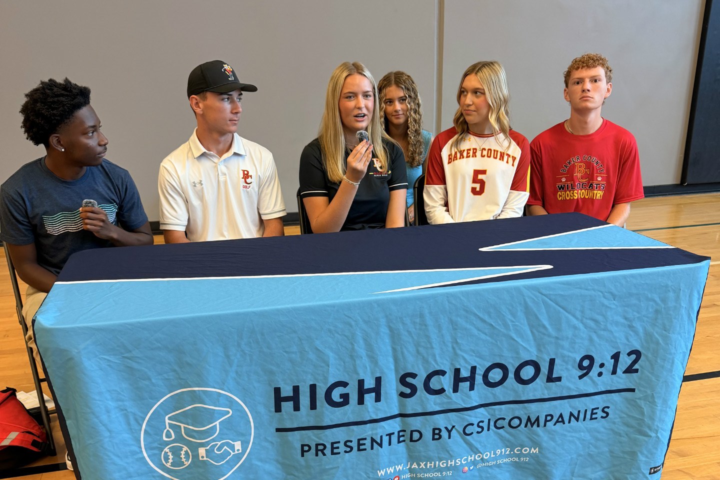 Student-athletes at the High School 9:12 media day interview table